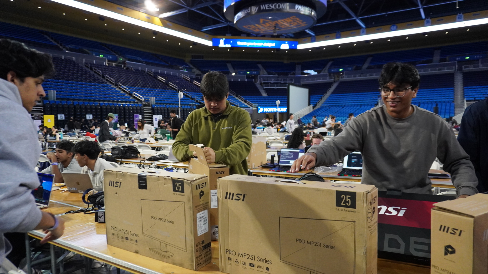 MSI team handing out laptops and monitors to hackers